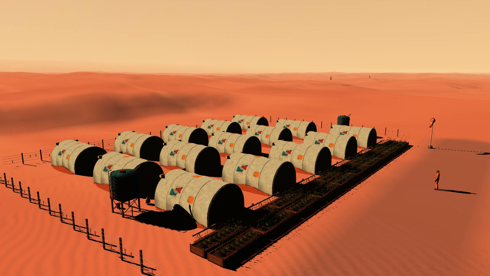 Rows of greenhouse shelters and a water tank in the red dunes beyond Landfall